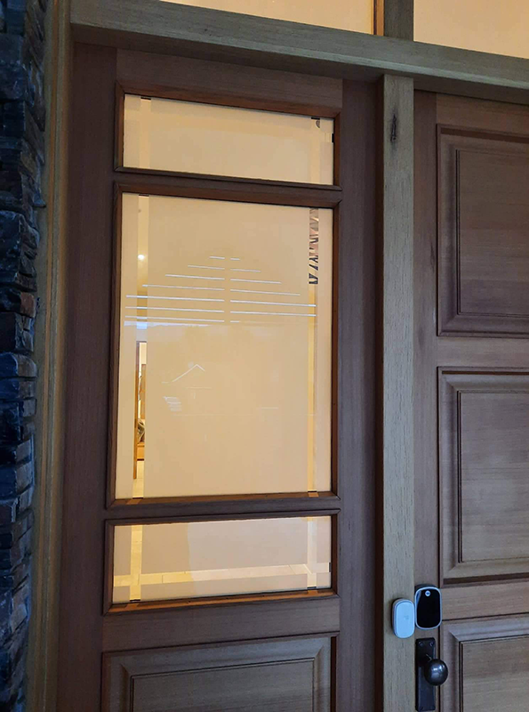 Sidelight and high tech lock on wooden door installed by Hoults Doors
