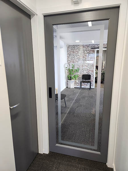 Glass office door provided by Hoults Doors.